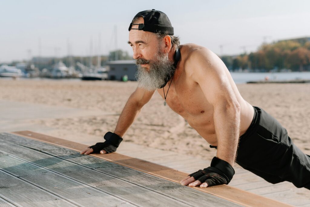 Older man doing exercise on a beach