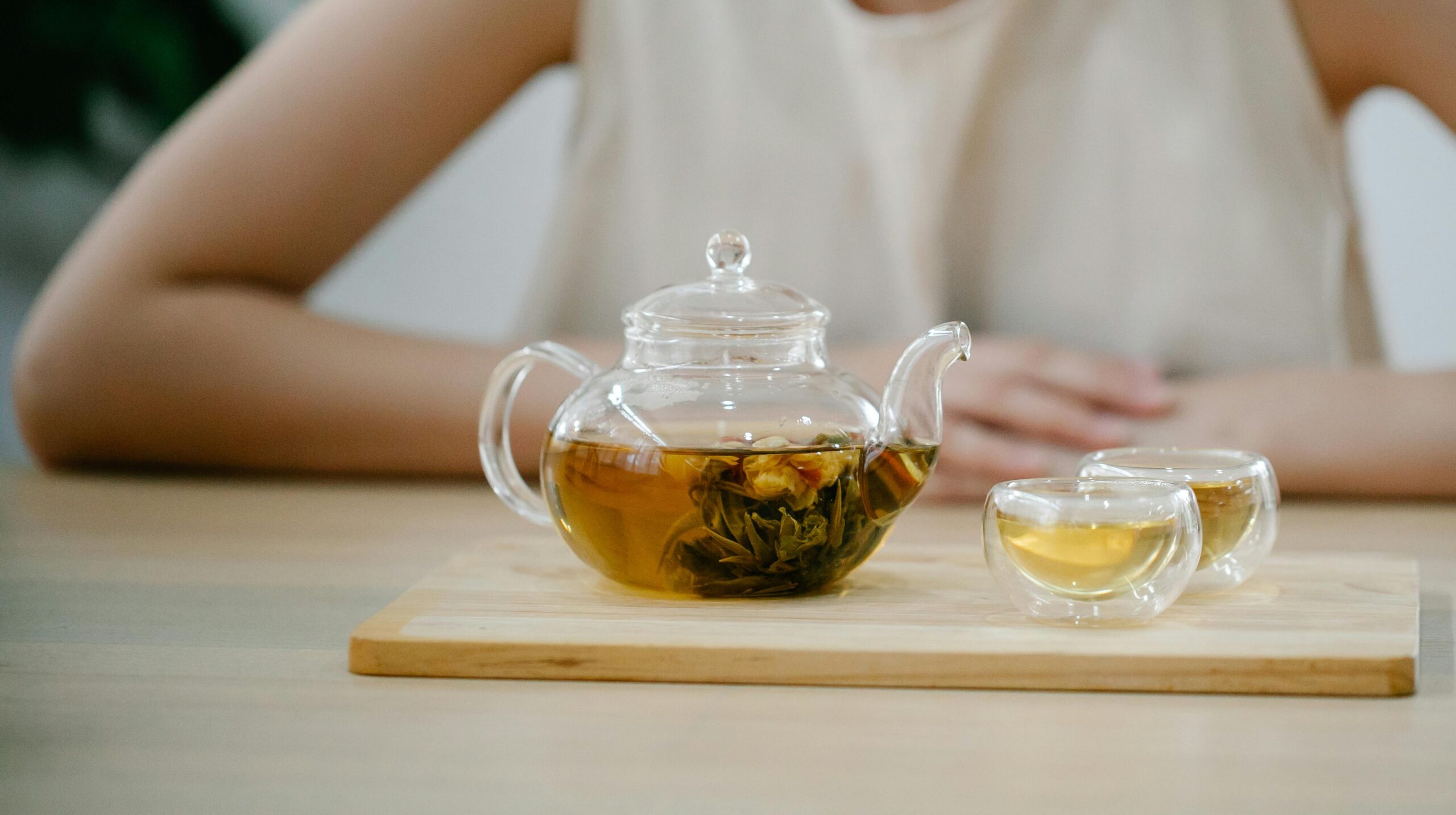 Woman sitting at a table with a glass of tea