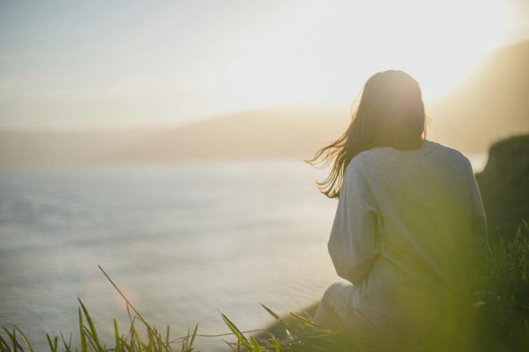 Woman sitting on a river bank