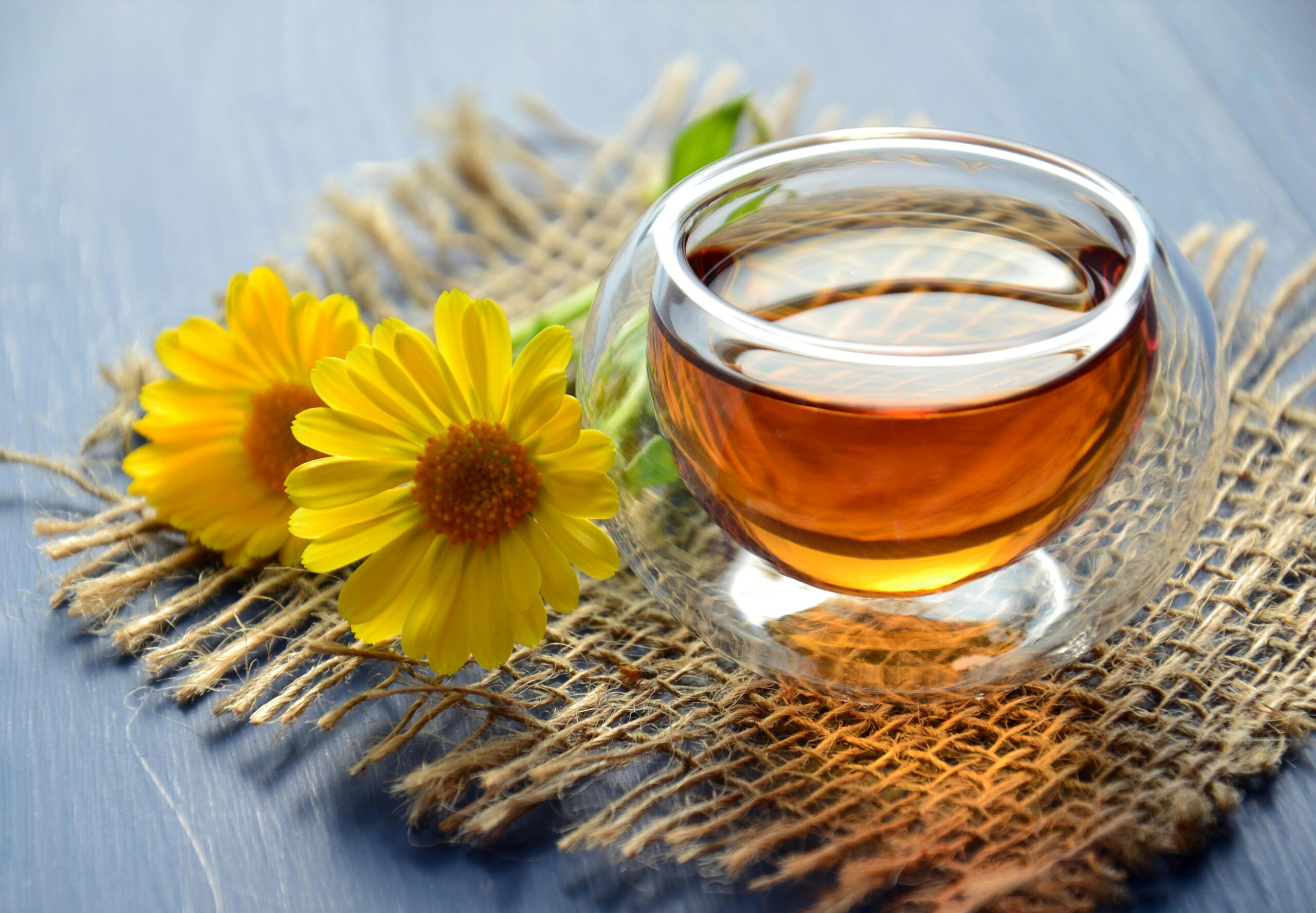 Tea on a table with flowers by the side