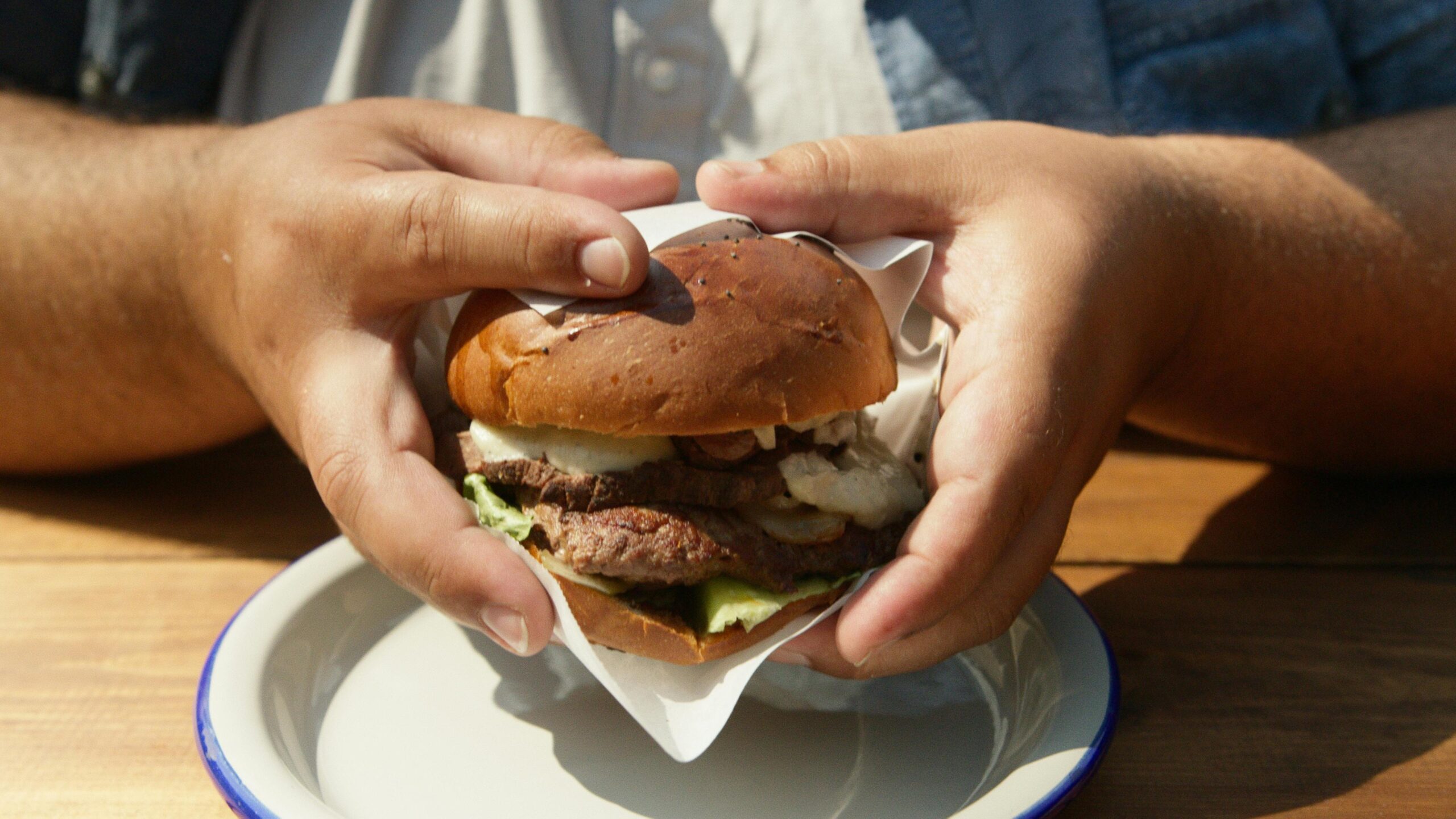 A hand holding a burger